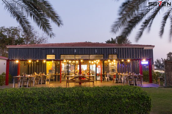 A warmly lit, industrial-chic outdoor seating area of Seven Star interior design company in Dubai, showcasing residential interior design services Dubai and expertise as commercial fit-out specialists in UAE.